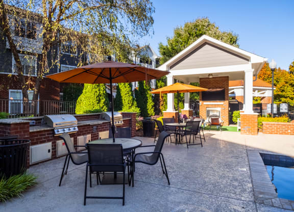 our apartments have a large patio with tables and umbrellas