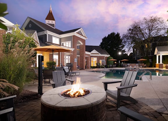 A backyard with a fire pit and a pool.