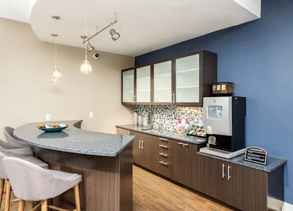 A kitchen with a blue wall and a counter with a bowl on it.