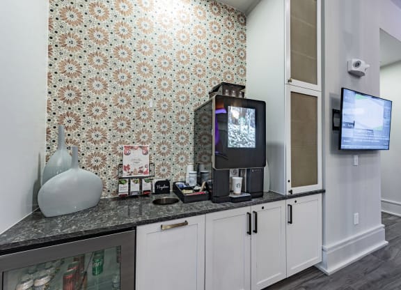 a kitchen with a counter top and a tv