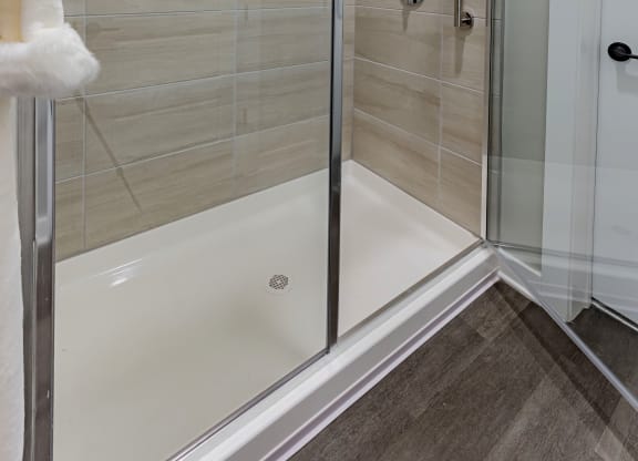a shower with a glass door in a bathroom