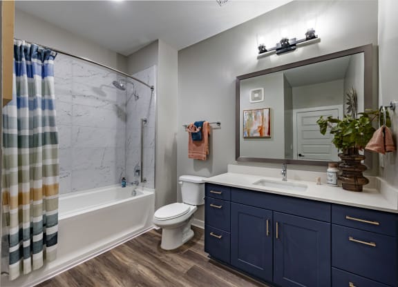 the residence on lamar apartment bathroom with shower sink and toilet