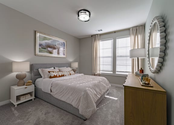 a bedroom with a bed and a dresser and a window
