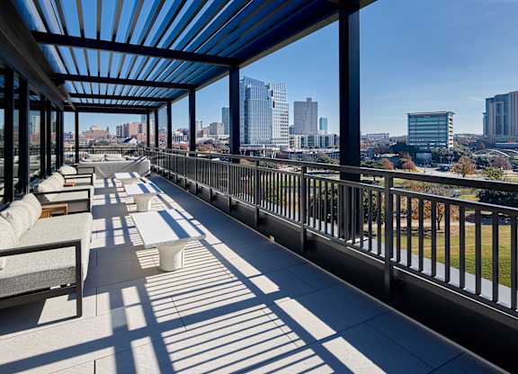 A long balcony with a view of the city.