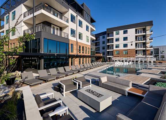 A modern building with a pool in front.
