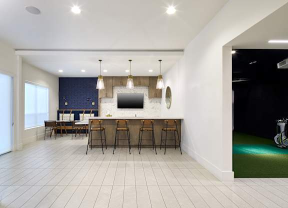 A modern kitchen with a dining table and chairs.