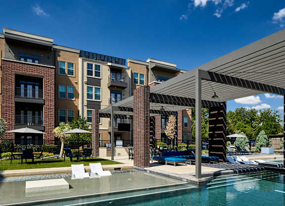 A modern building with a pool in front.