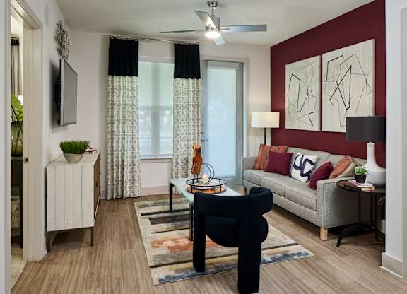 A living room with a black chair and a white sofa.