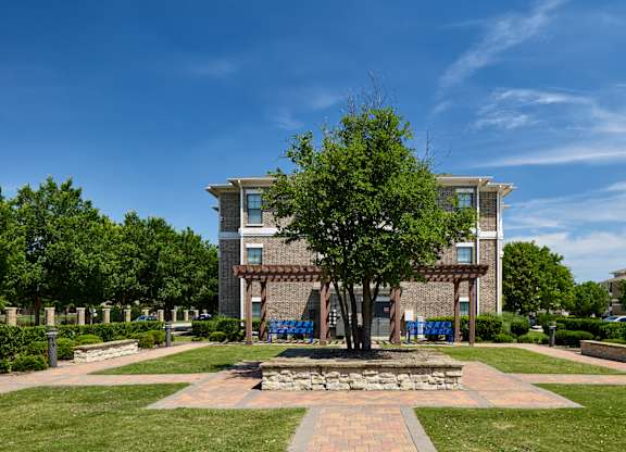 A large building with a tree in front of it.