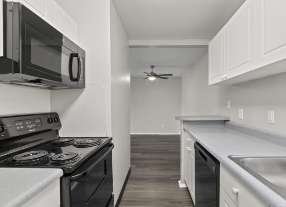 Kitchen with white cabinets and a black stove top oven at Creve Coeur, Creve Coeur, MO