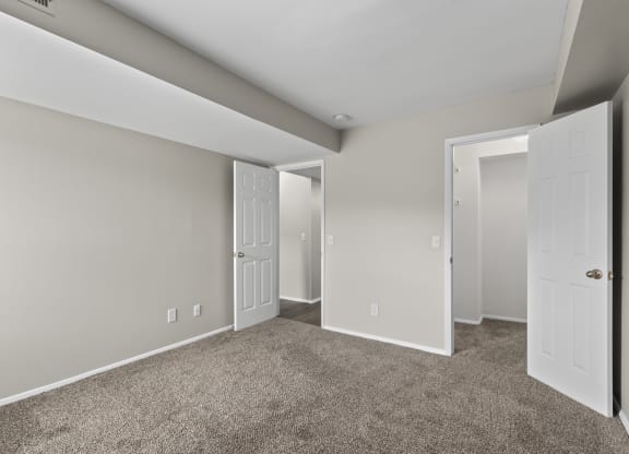 Bedroom with a carpeted floor and two doors at Creve Coeur, Creve Coeur, MO