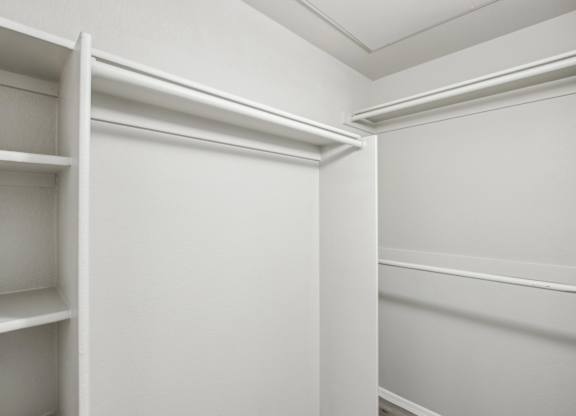 A white closet with shelves and a door at Sweetwater At Metro North Apartments, Phoenix, Arizona