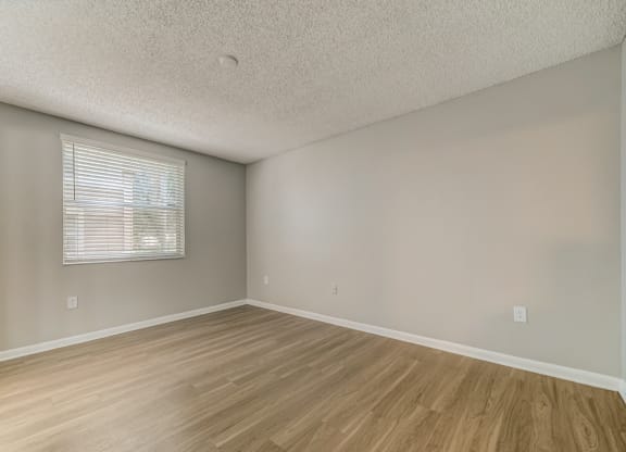 Bedroom with window and wood style flooring at Pembroke Pines Landings, Pembroke Pines, FL, 33025