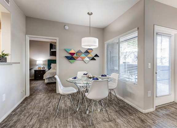 A dining room with a white table and chairs at Sweetwater At Metro North Apartments, Phoenix, AZ