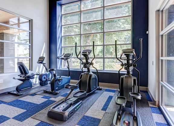 A room with a row of exercise bikes at Sweetwater At Metro North Apartments, Phoenix, AZ 85029