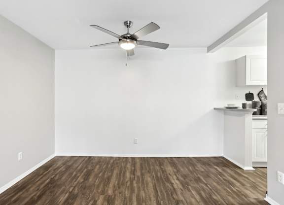 A room with a ceiling fan and wooden flooring. at Millennium at Creve Coeur, Missouri