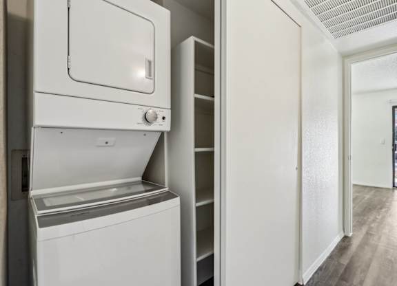 A white dishwasher and oven in a kitchen.