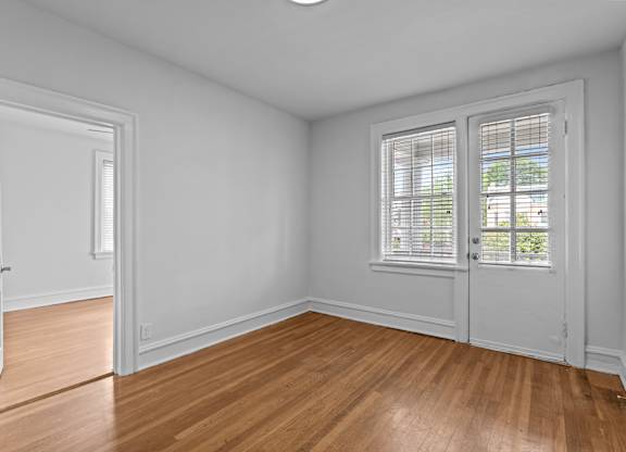A room with a wooden floor and white walls.