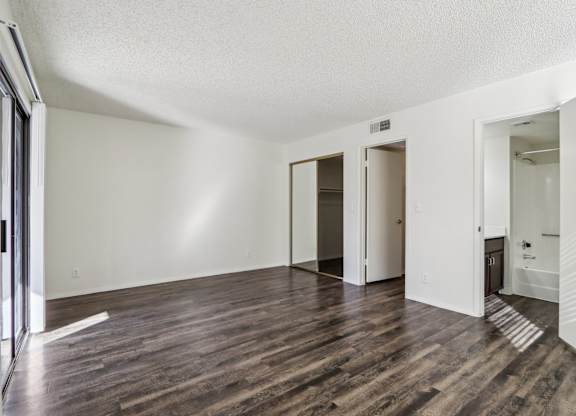 A room with wooden floors and white walls.