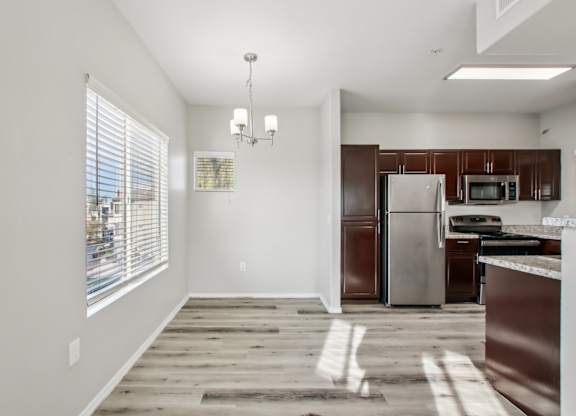 A kitchen with a refrigerator, microwave, and oven at Sweetwater At Metro North Apartments, Phoenix