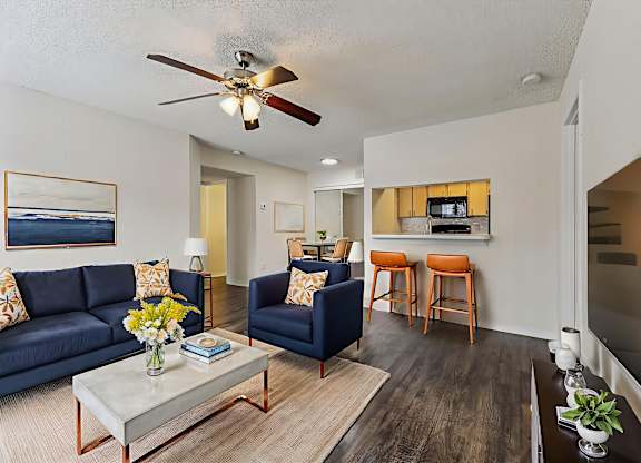 A living room with a blue couch and a coffee table.