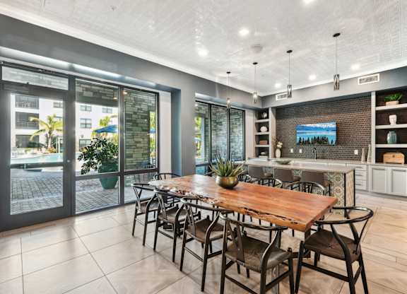 A modern dining room with a wooden table and chairs.