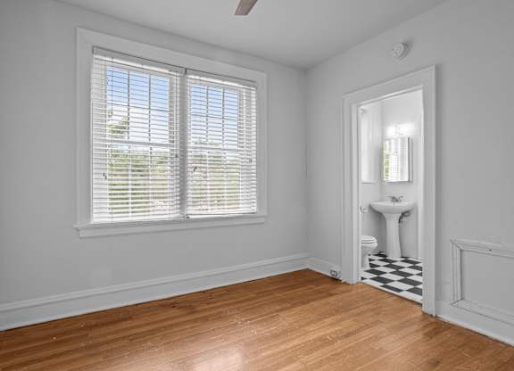 A room with a window and a sink in it.