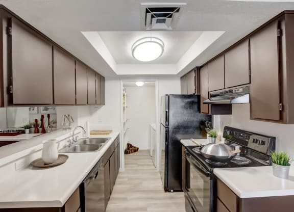 a kitchen with dark cabinets and white countertops at Glen at Mesa Apartments, AZ 85201