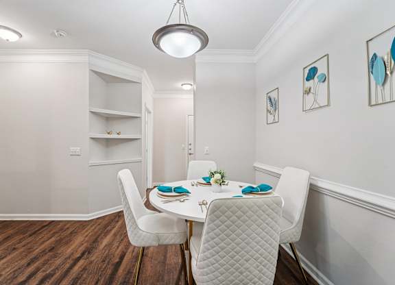 A dining room with a table set for two.
