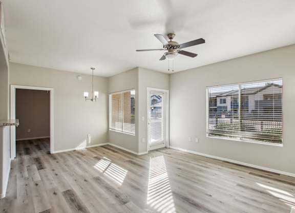 A spacious room with a ceiling fan and wooden flooring at Sweetwater At Metro North Apartments, Arizona 85029