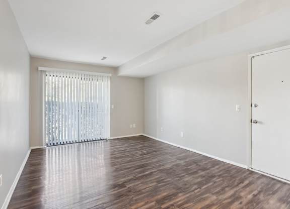 A room with wooden floors and a white door. at Millennium at Creve Coeur, Creve Coeur