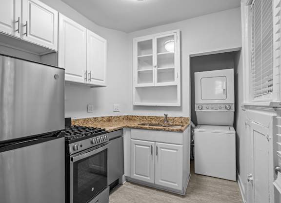 A kitchen with a stove, oven, and refrigerator.
