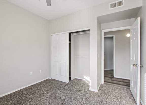 A room with a carpeted floor and white walls at Sweetwater At Metro North Apartments, Arizona 85029
