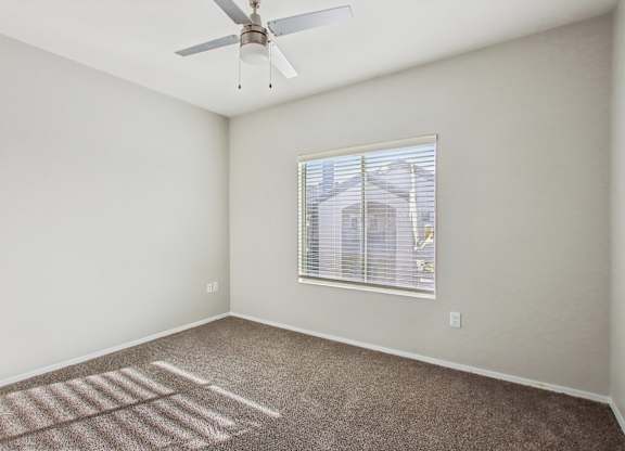 A room with a ceiling fan and a window at Sweetwater At Metro North Apartments, Phoenix  85029