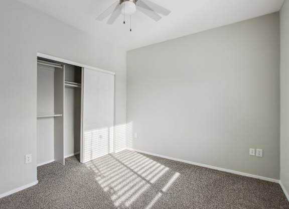 A room with a ceiling fan and a carpeted floor at Sweetwater At Metro North Apartments, Phoenix  85029