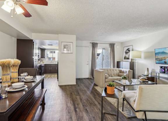 A living room with a dining table and chairs.