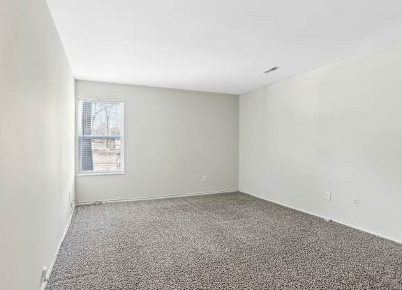 Empty room with carpeted floor and a window. at Millennium at Creve Coeur, Creve Coeur