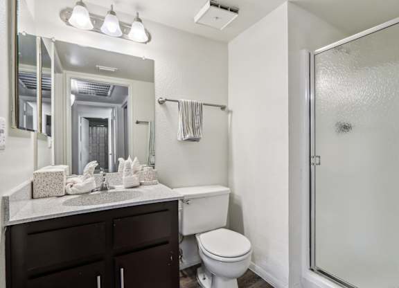 A white toilet sits next to a sink in a bathroom.