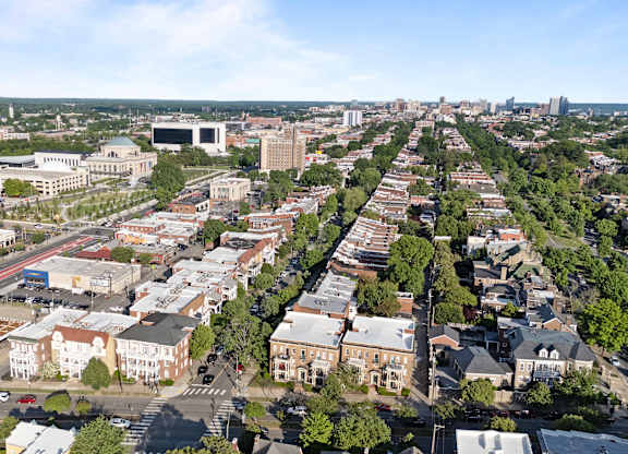 A city street with buildings on both sides and a clear sky.