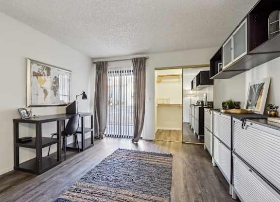 A room with a desk and a chair in it.