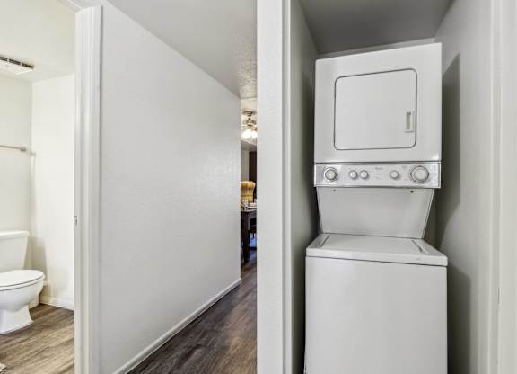 A white toilet with a tank built into a wall.