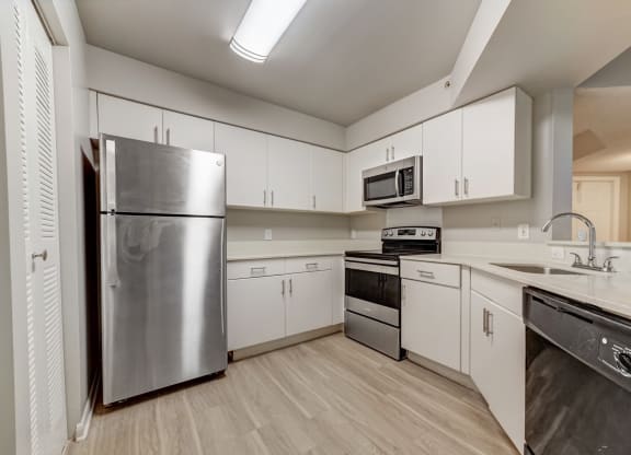 Kitchen with white cabinetry at Pembroke Pines Landings, Pembroke Pines, FL, 33025