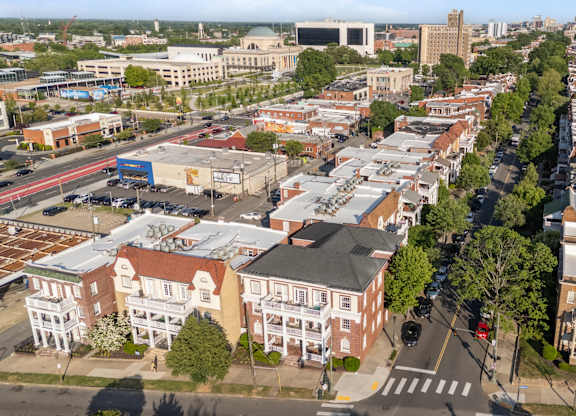 A city street with buildings on both sides and a crosswalk in the middle.