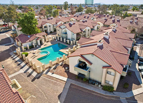 A large group of houses with a pool in the middle.