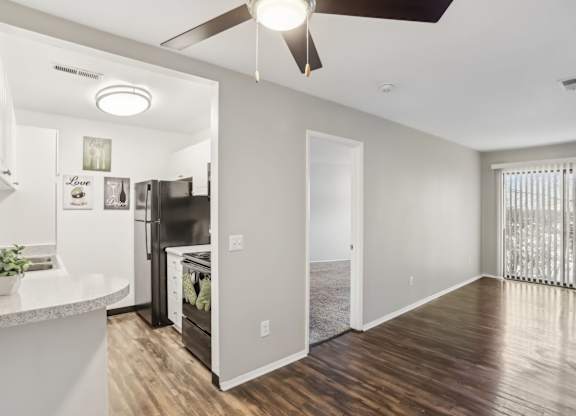 A modern kitchen with a refrigerator, oven, and a ceiling fan.at Creve Coeur, Creve Coeur, 63141