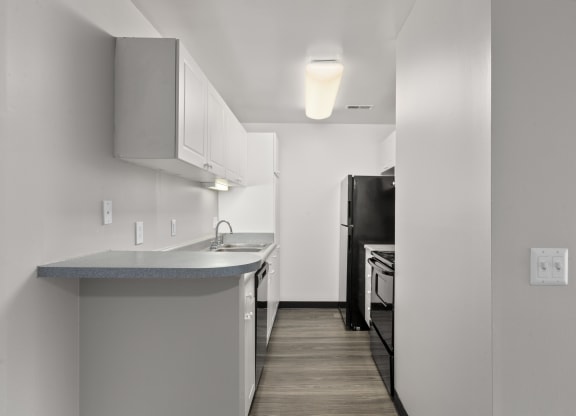 Kitchen with white cabinets and a black refrigerator at Creve Coeur, Creve Coeur, MO