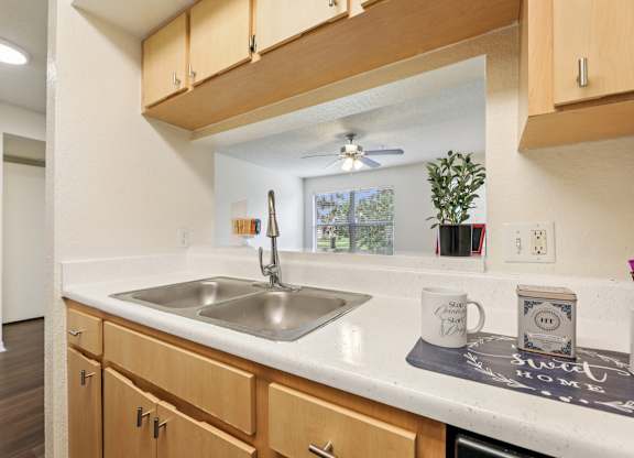 A kitchen with wooden cabinets and a white countertop.