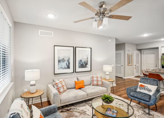 a living room with a couch and a ceiling fan at Edge75, Naples, Florida 34104