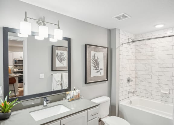 a white bathroom with a shower and a sink and a mirror at Edge75, Naples, Florida 34104