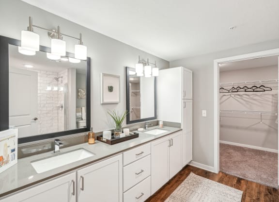 a white bathroom with two sinks and a mirror at Edge75, Naples, Florida 34104